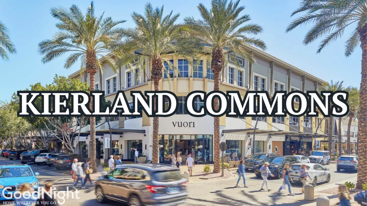 A lively street scene at Kierland Commons, featuring palm trees, stylish shopfronts, and bustling sidewalks under a sunny sky. The ambiance is vibrant, showcasing one of Scottsdale’s premier shopping and dining destinations.